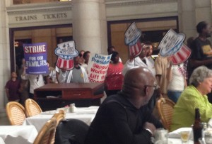 Demonstrators file through the Main Hall at Union Station during the lunch rush.